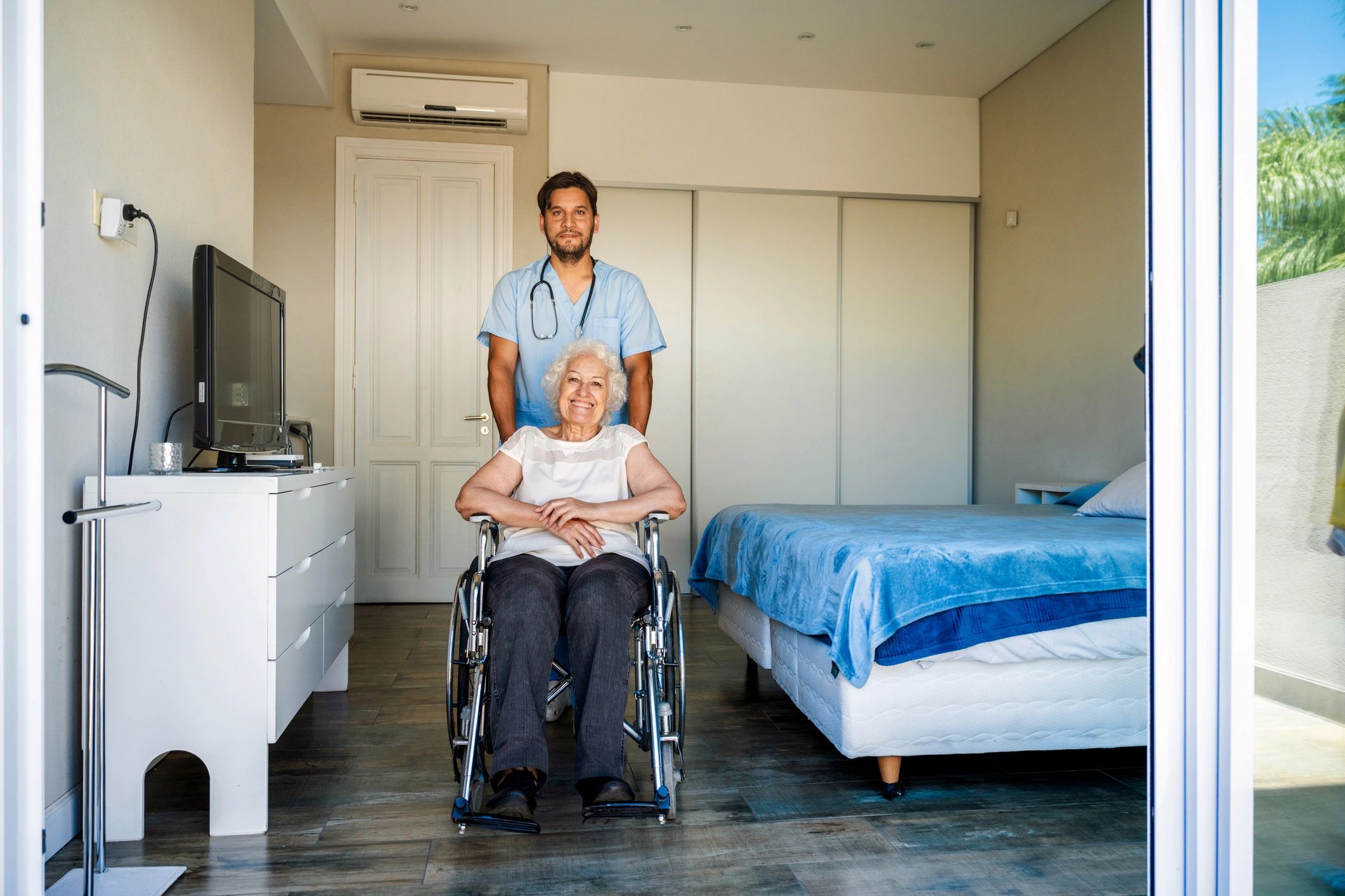 Care professional assisting a senior patient using a wheelchair